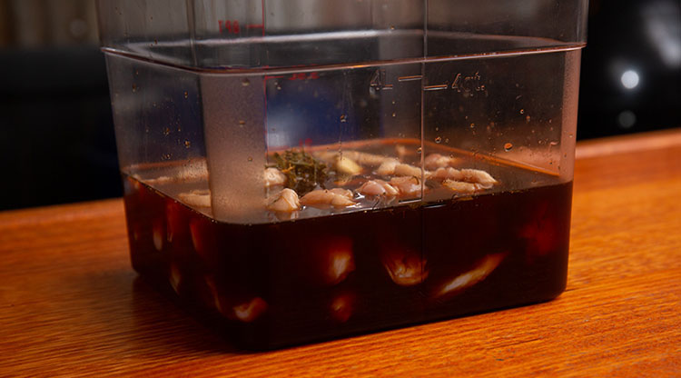 Chicken wings in brine in large tub
