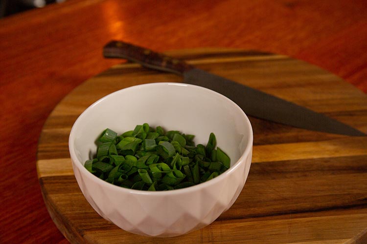 chopped green onions in a white bowl