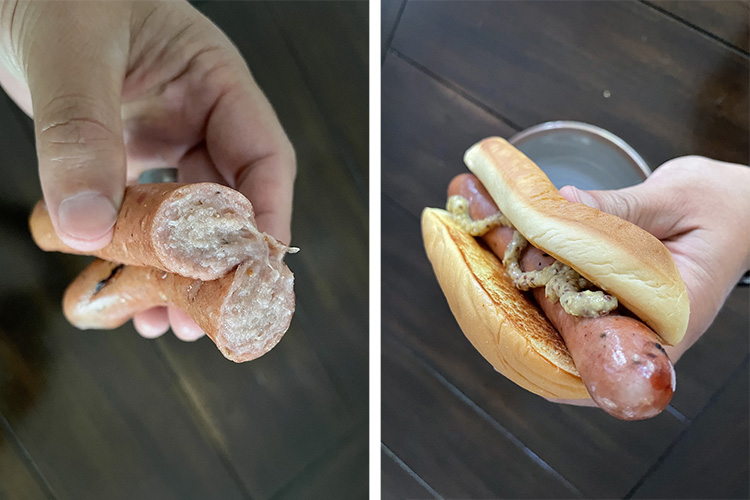 a man holding smoked homemade hotdog in a bun