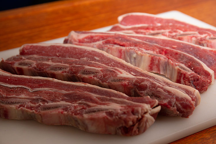 raw Korean short beef ribs on a plastic board