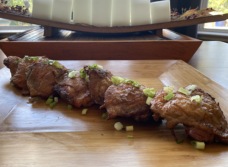 smoked chicken thighs on a wooden board