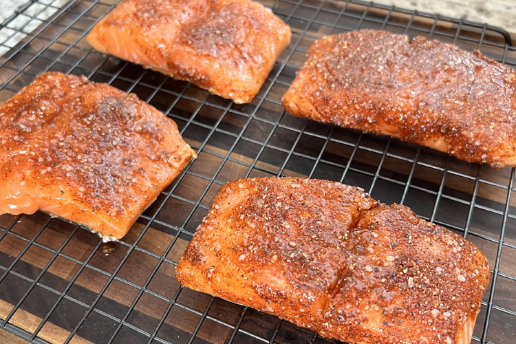 seasoned raw salmon on a wire rack