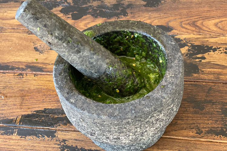 pestle and mortar with pounded herbs