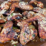 cooked garlic, butter, parmesan wings on a plate