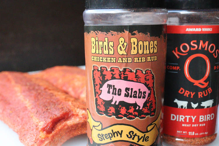 2 branded rubs and coated pork ribs in background