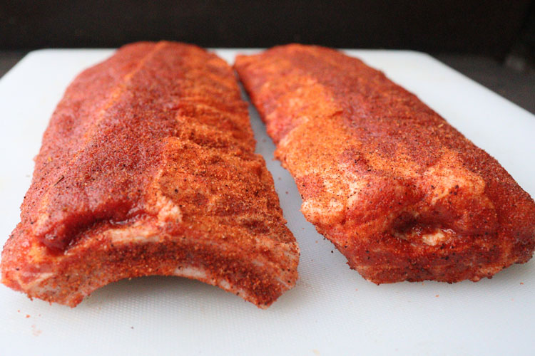 seasoned pork ribs on a chopping white chopping board