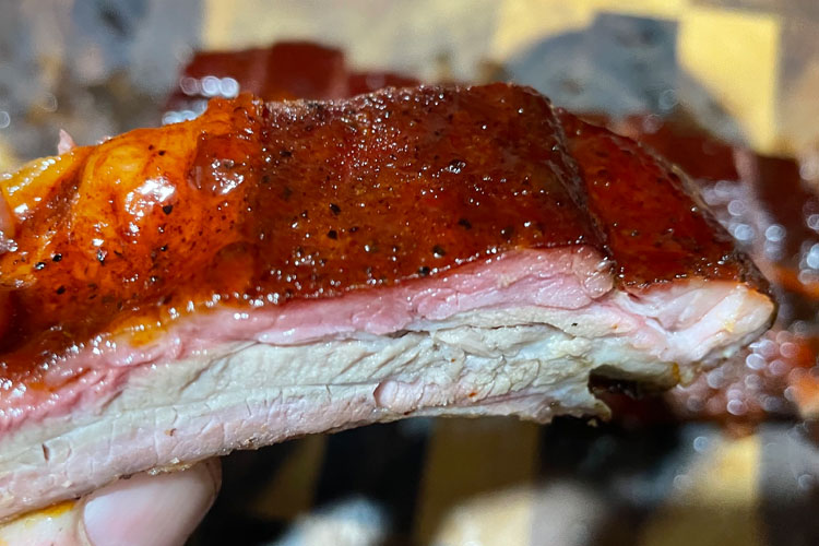 side view of cooked and sliced individual rib