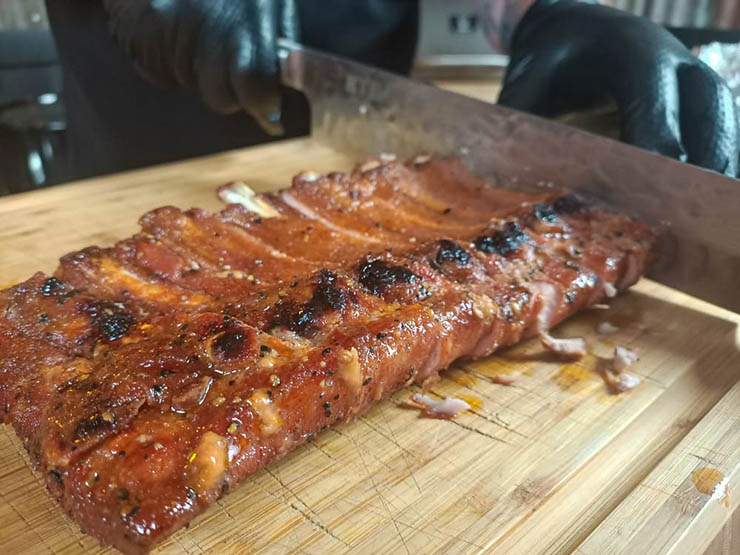 slicing smoked baby back ribs