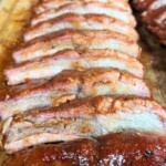 smoked baby back ribs on a wooden board