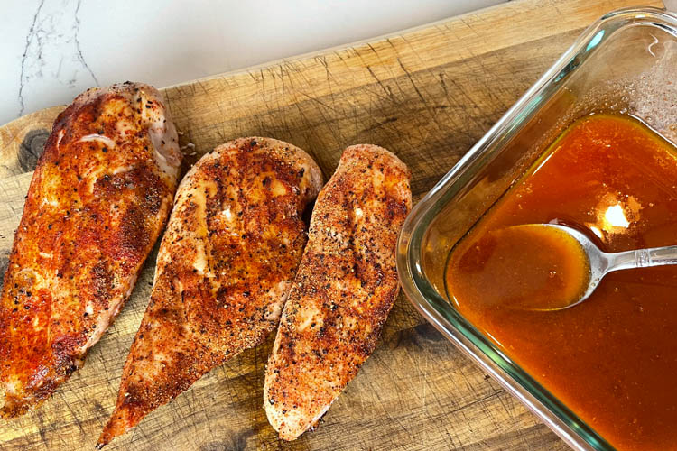 cooked chicken with bowl of sauce and spoon