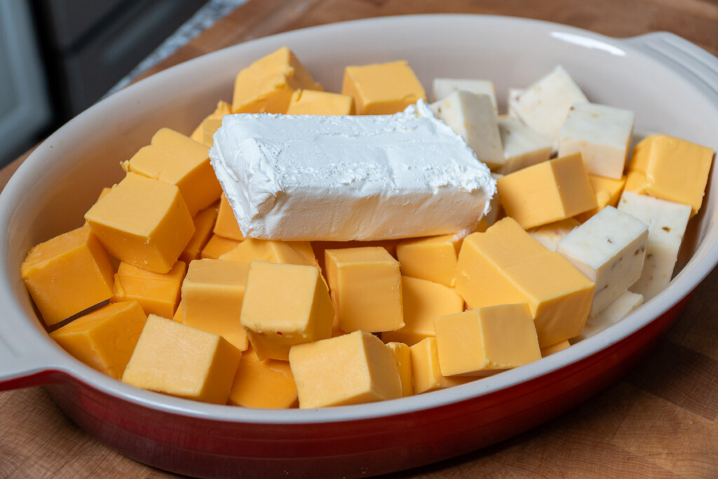 queso cheese cubbed with a block of cream cheese on top