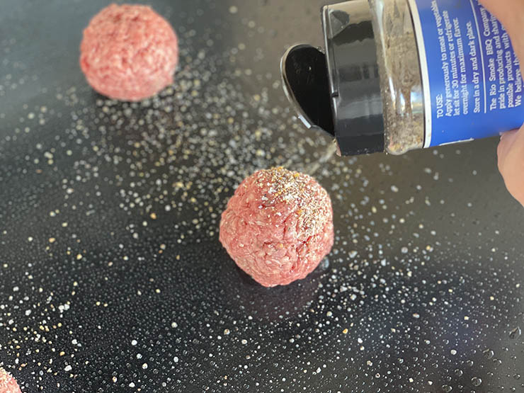 beef meat balls on a griddle with seasoning