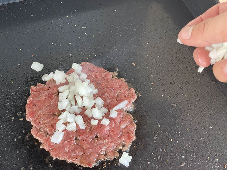 smashed burger patty with chopped onions