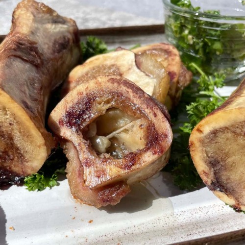 cooked smoked bone marrow on a white platter