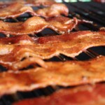 strips of smoked candied bacon on a wire rack