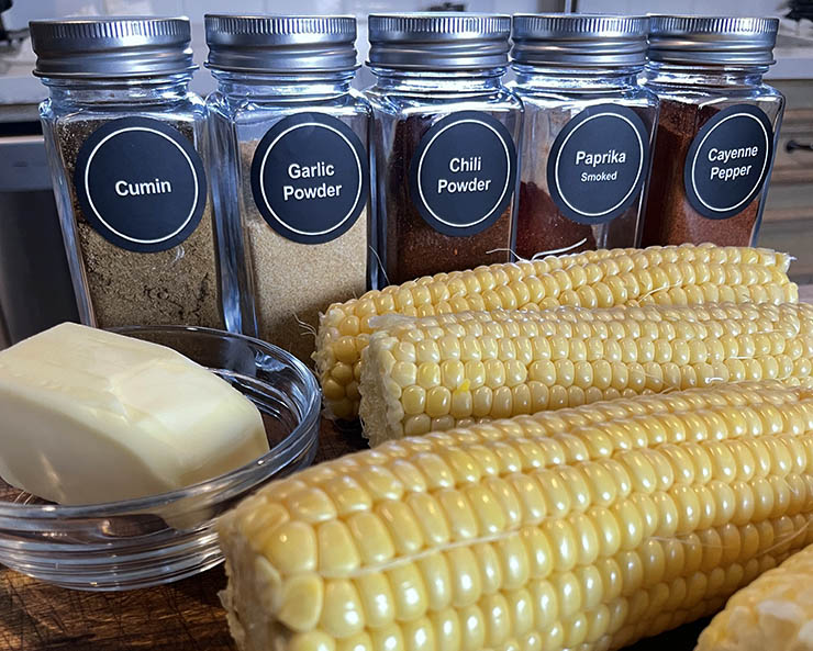 corn cobs, butter and spices on the table