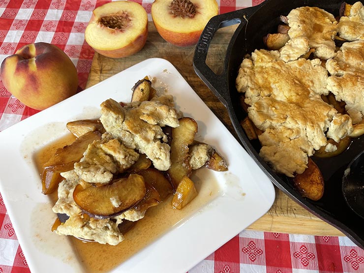 smoked peach cobbler served on a white plate