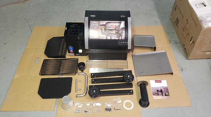 Camp Chef DLX 24 assembly parts on a cardboard