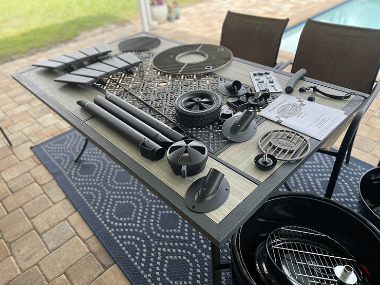 Char-griller akorn kamado grill assembling pieces laid out on a table