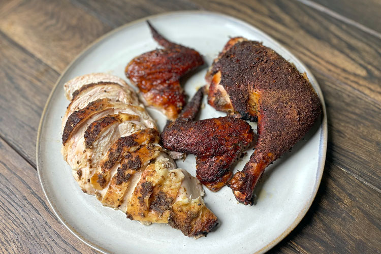 carved chicken on a white plate