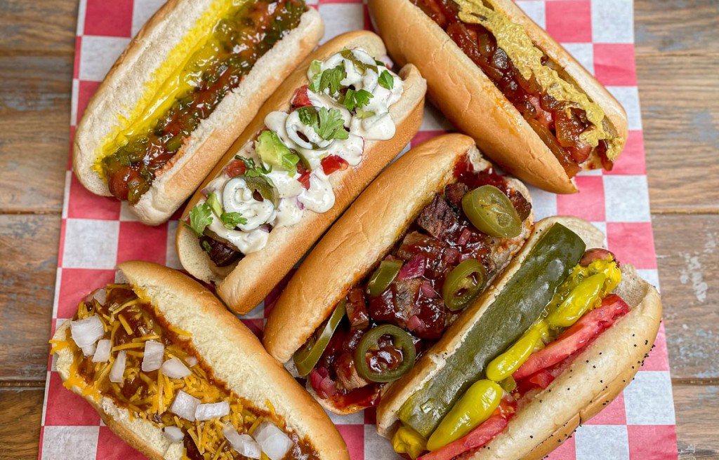 7 differant hotdogs on red checked napkin