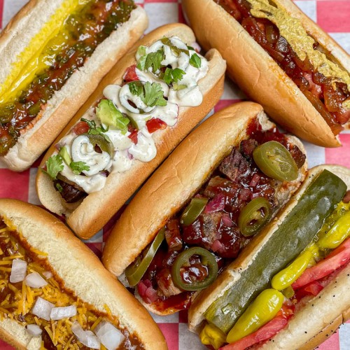 7 differant hotdogs on red checked napkin