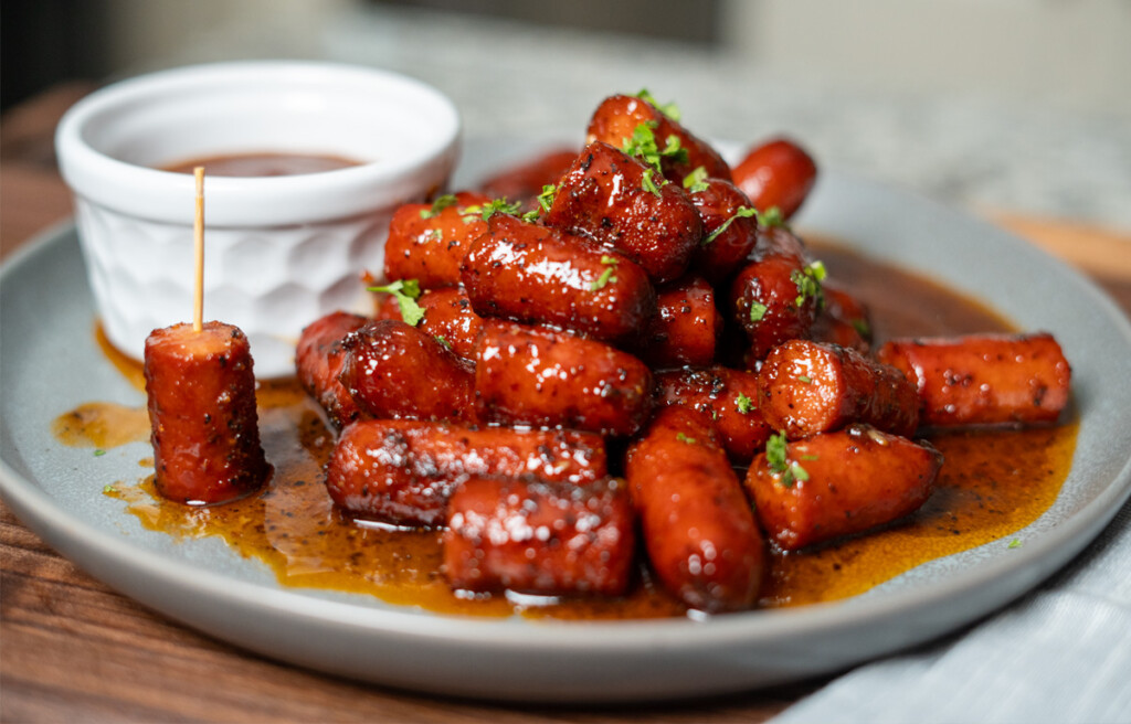 plate of hot dog burnt ends with dipping sauce