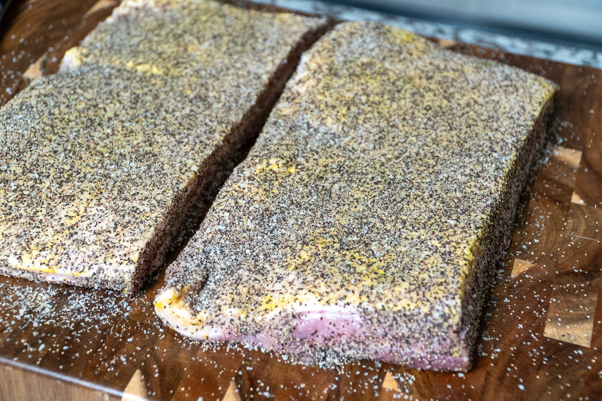 raw pork belly with seasoning all over it
