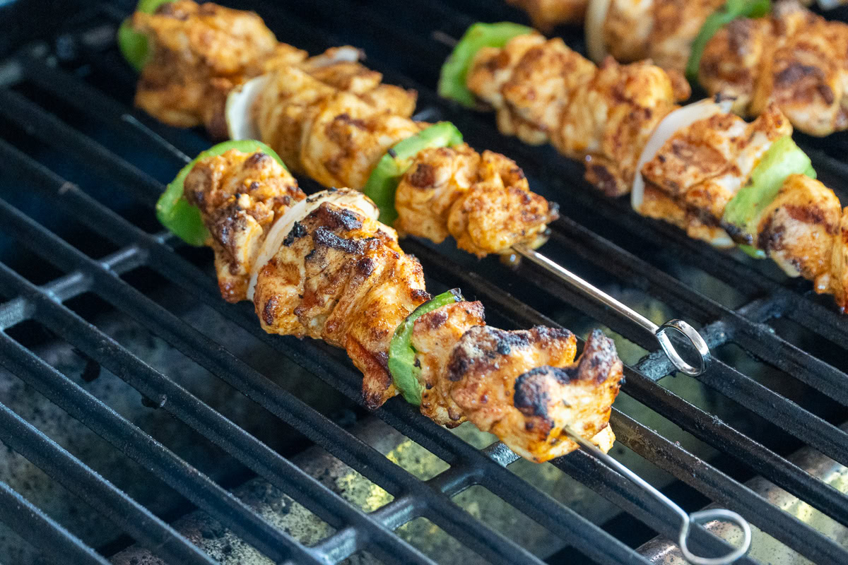 a cooked chicken skewer with nice char on the grill