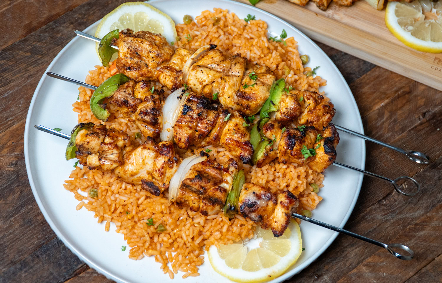 grilled fajita chicken skewers on a bed of mexican rice