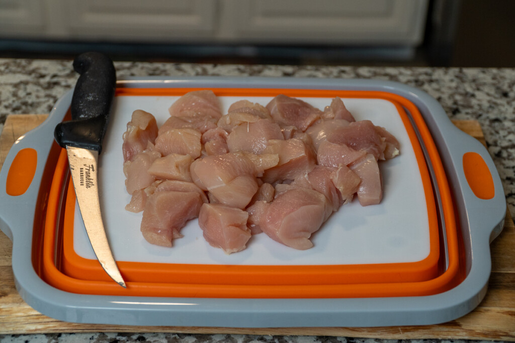 cubed raw chicken on a white board