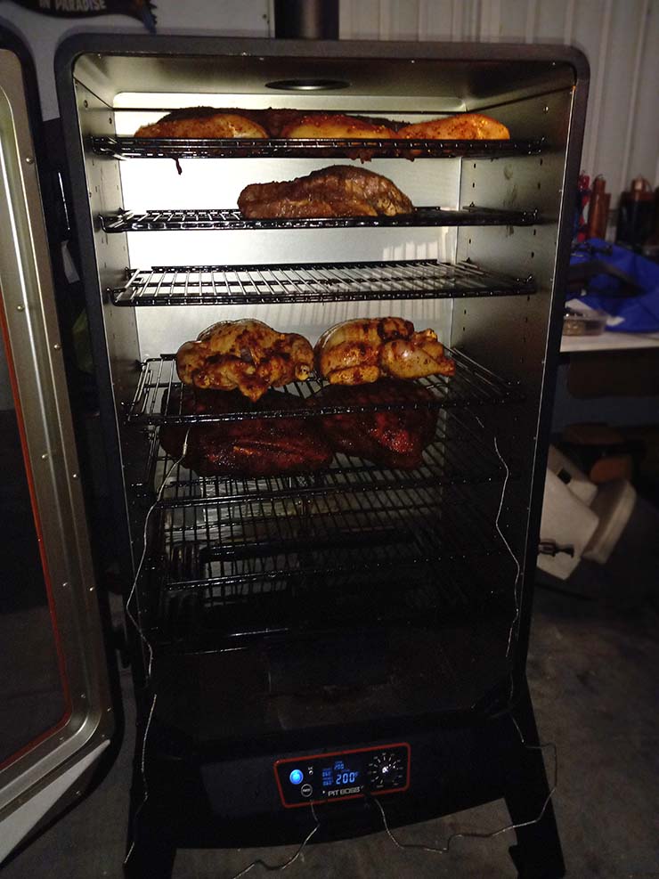 meat smoking inside a Pit Boss Sportsman 7-Series Vertical Pellet Smoker