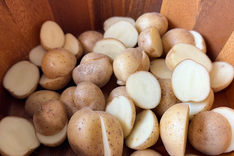 raw chopped potatoes in a mixing bowl