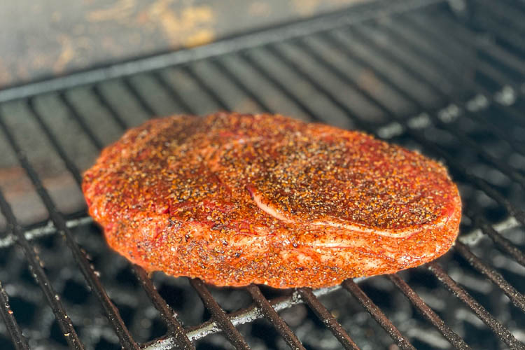 seasoned ribeye on the grill