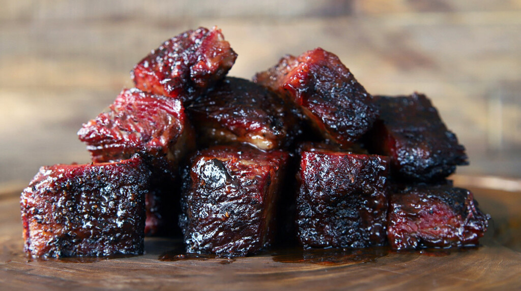 brisket burnt ends stacked on a wood board