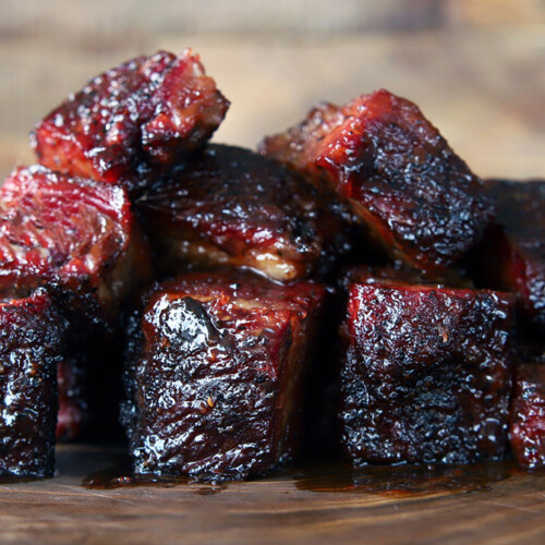 brisket burnt ends stacked on a wood board