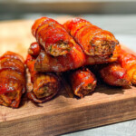 smoked jalapeno popper shotgun shells on a wooden board