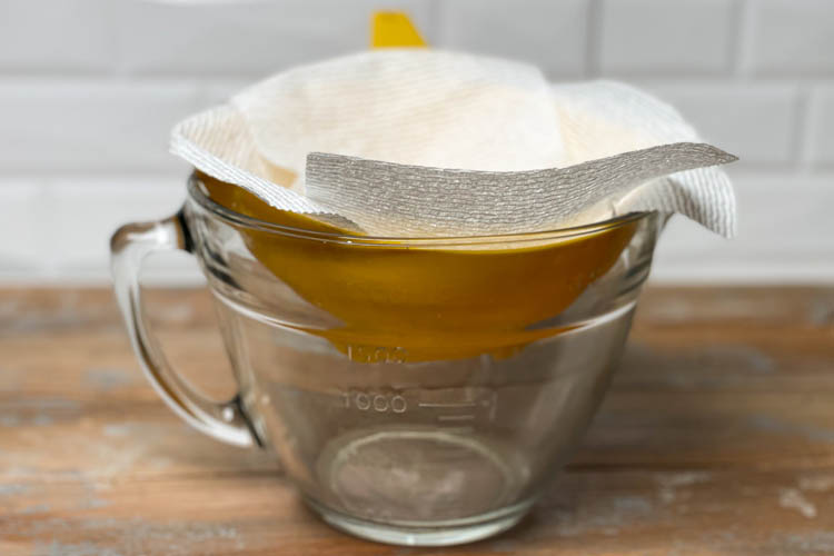 jug with paper towels as sieve with rendered fat in it