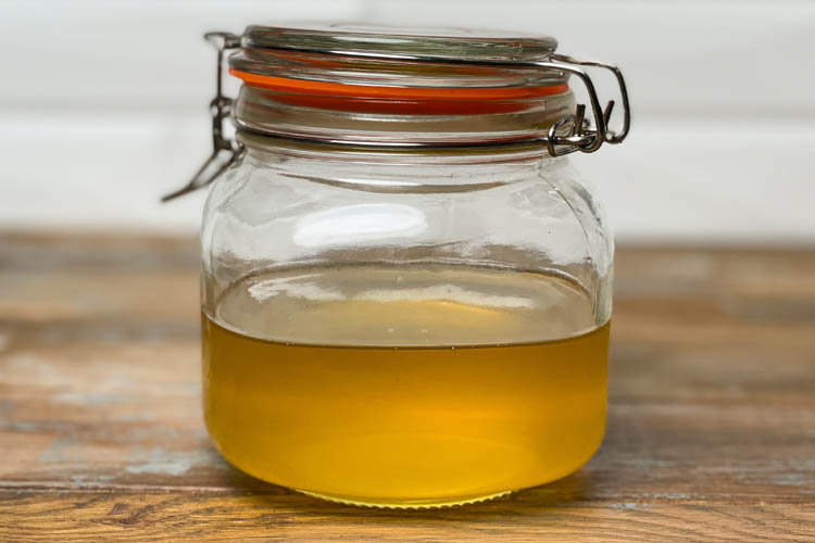 warm tallow in a mason jar