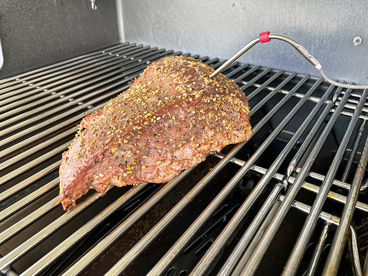 a piece of meat with a temperature probe cooking on Weber Genesis SPX-435 gas grill