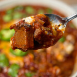 a spoon with smoked brisket chili with beans