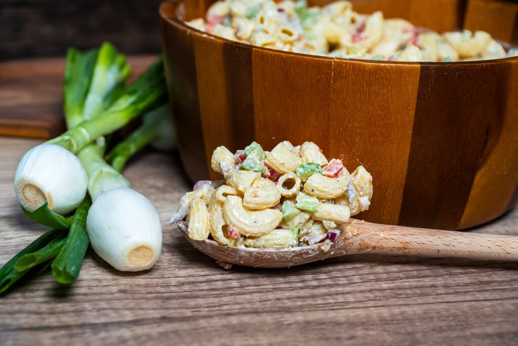 macaroni salad on a wooden spoon