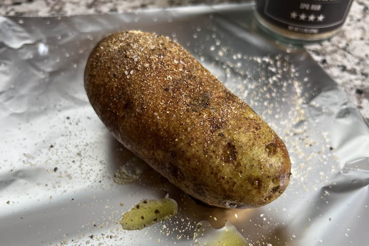 raw seasoned potatoe on foil