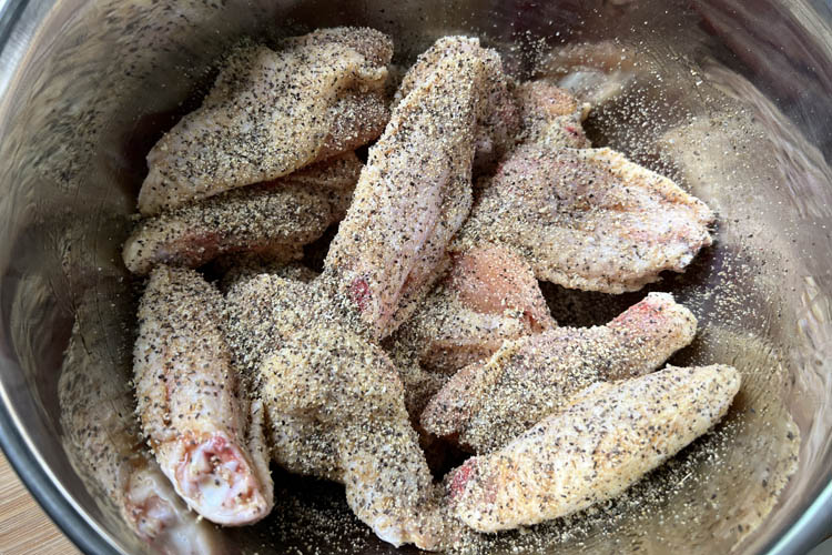 raw sesoned wings in a bowl