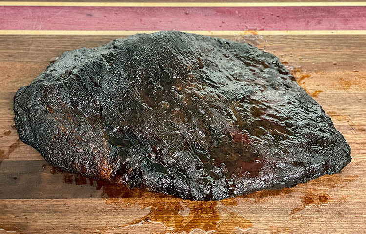 whole smoked brisket on butcher block