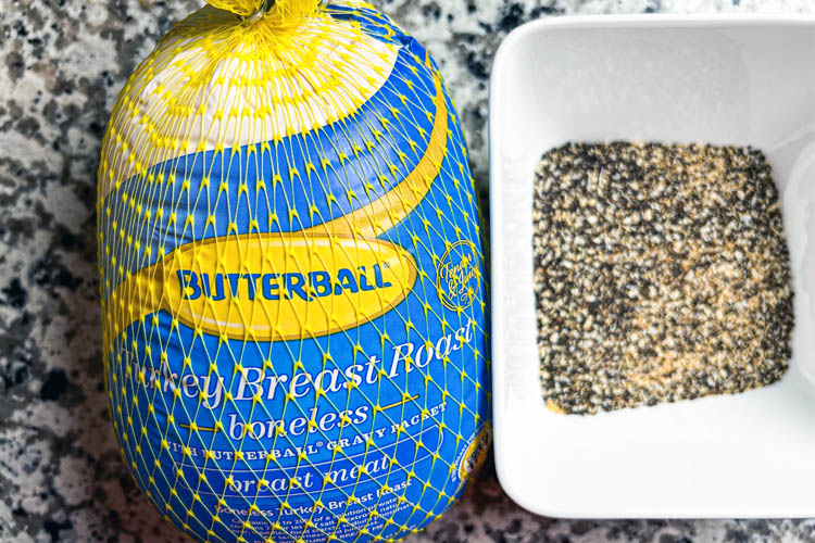 turkey breast in packaging and white bowl with dry rub
