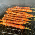smoked bacon wrapped carrots with maple glaze on a pellet grill