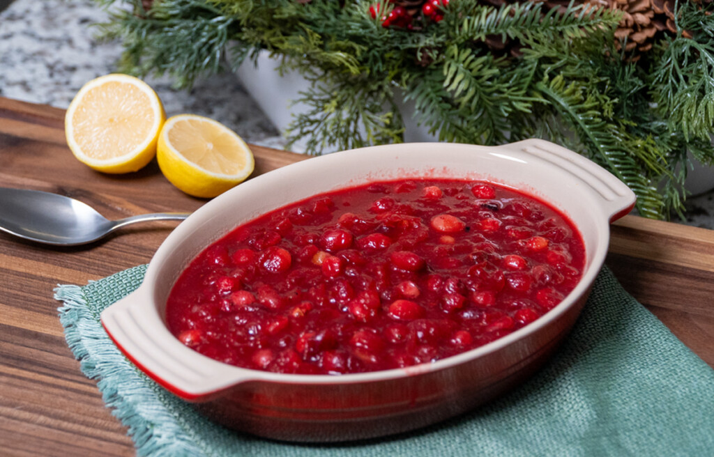bowl of cranberry sauce with Christmas ornament in background
