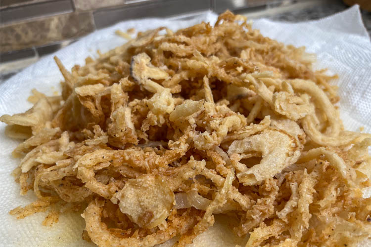 deep fried onions on a white plate