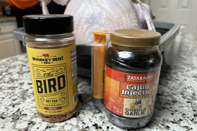 a jar of seasoning and a jar of cajun ingection